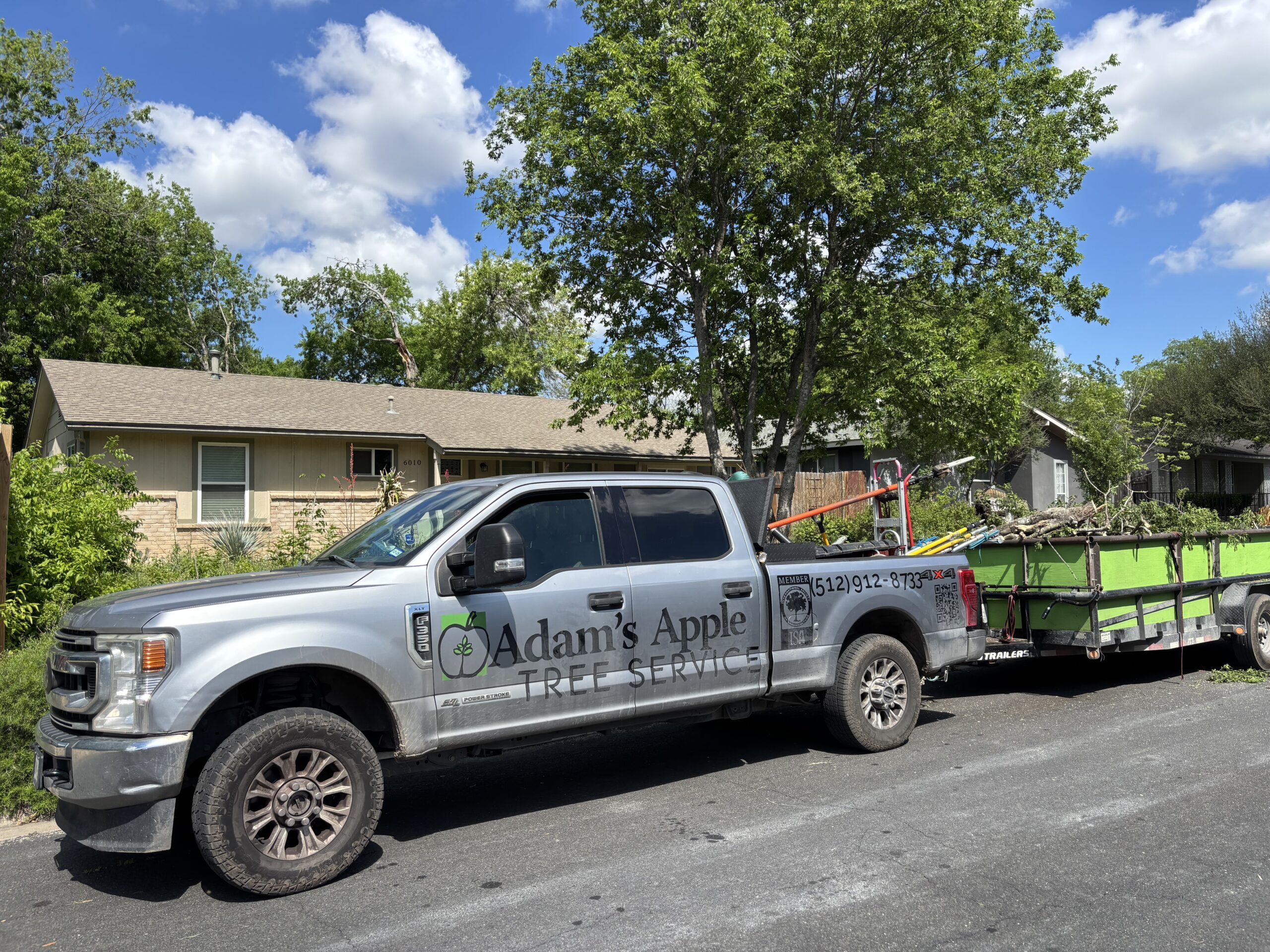 Adam's Apple Tree Service truck parked in Austin TX residential neighborhood